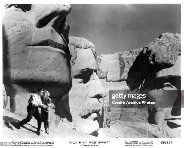 Cary Grant and Eva Marie Saint walking near the faces on Mt. Rushmore in a scene from the film 'North By Northwest', 1959.