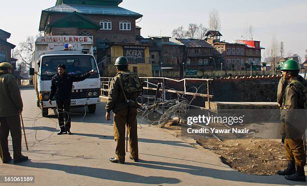 Indian paramilitary soliders stop an ambulance carrying patients during a curfew after Mohammad Afzal Guru was executed for plotting to attack...