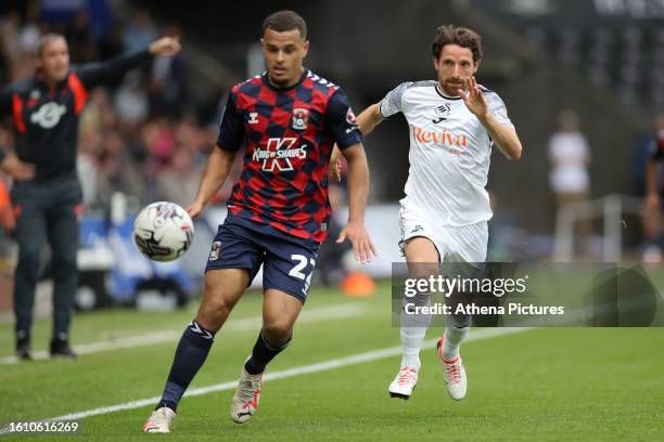 Joel Latibeaudiere of Coventry City is chased by Joe Allen of Swansea City during the Sky Bet Championship match between Swansea City and Coventry...