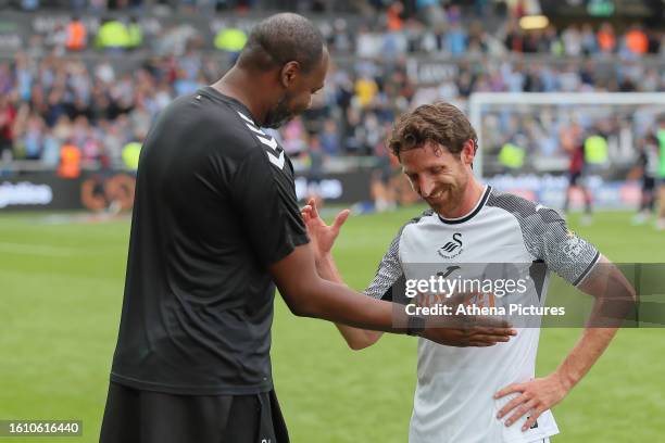 Dennis Lawrence, coach for Coventry City shakes hands with Joe Allen of Swansea City after the Sky Bet Championship match between Swansea City and...