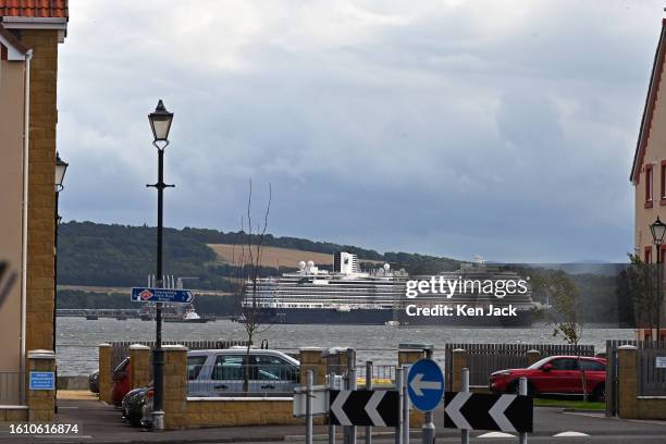 The Holland America Line cruise ship Nieuw Statendam looms large between the houses on the Fife shore as she lies at anchor near the Forth Bridge,...