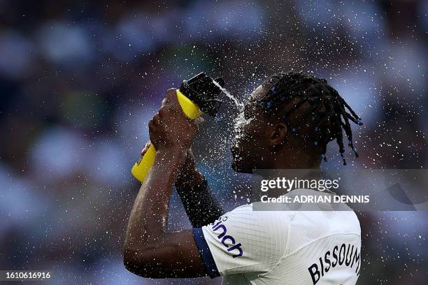 Tottenham Hotspur's Ivorian-born Malian midfielder Yves Bissouma sprays his face with water before the English Premier League football match between...