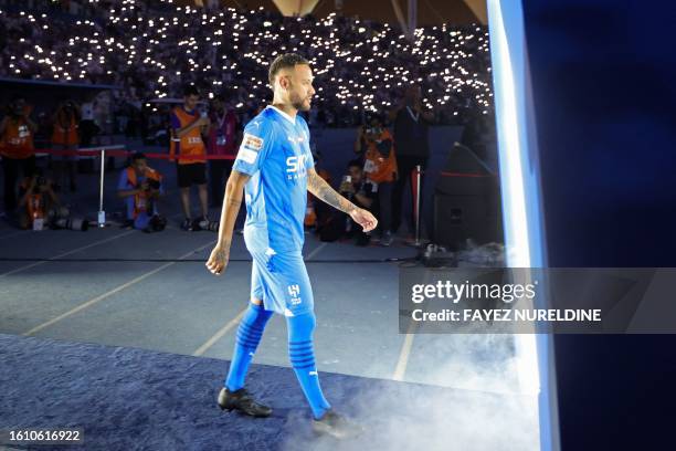 Brazilian superstar Neymar enters the pitch during his unveiling ceremony at Al-Hilal in Riyadh on August 19, 2023 as he becomes the latest...