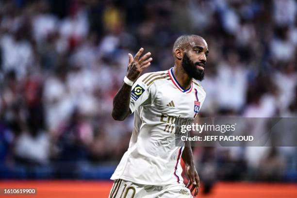 Lyon's French forward Alexandre Lacazette celebrates scoring his team's first goal during the French L1 football match between Olympique Lyonnais and...