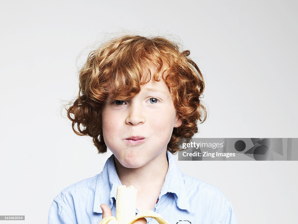 Boy eating banana