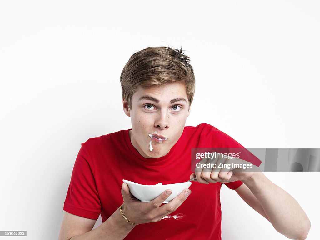 Young man eating cereal