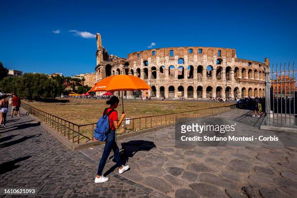 Tourists with umbrellas to protect themselves from the sun at Colosseo area , during heatwave "Nerone" on August 19, 2023 in Rome, Italy. Italian...