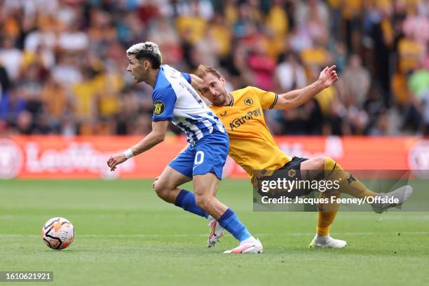 Julio Enciso of Brighton and Hove Albion dribbles past Craig Dawson of Wolverhampton Wanderers during the Premier League match between Wolverhampton...