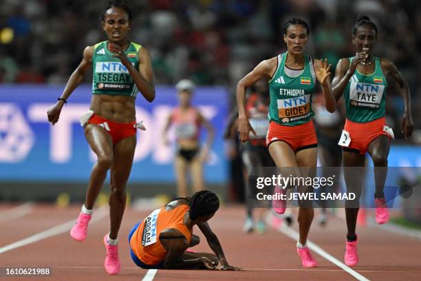 Ethiopia's Gudaf Tsegay, Letesenbet Gidey, and Ejgayehu Taye run past Netherlands' Sifan Hassan who felll while competing in the women's 10,000m...