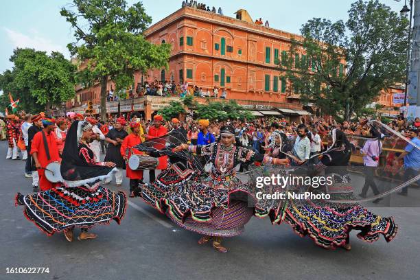 Rajasthani folk artists perform during a traditional procession on the occasion of 'Teej' festival, in Jaipur, Rajasthan, India, on Saturday, Aug 19,...