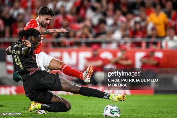 Benfica's Portuguese midfielder Rafa Silva vies with Estrela da Amadora's Angolan defender Kialonda Gaspar during the Portuguese league football...