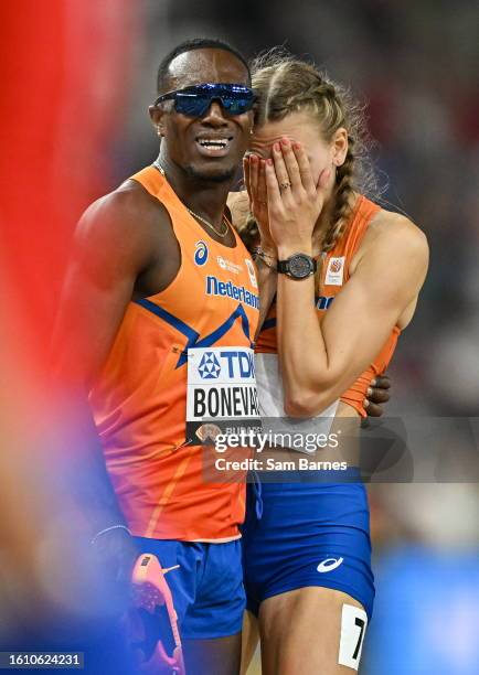 Budapest , Hungary - 19 August 2023; Femke Bol of Netherlands, right, is consoled by teammate Liemarvin Bonevacia after competing in the mixed 4x400m...