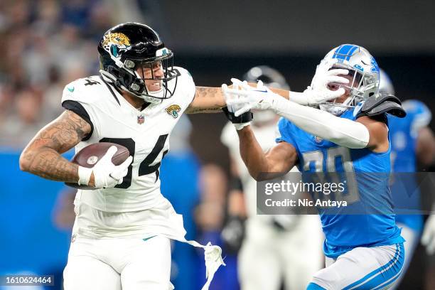 Elijah Cooks of the Jacksonville Jaguars stiff arms Khalil Dorsey of the Detroit Lions during the third quarter of the preseason game at Ford Field...