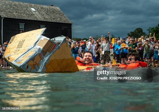 Team goes overboard as their boat sinks during the Great Salem Maritime Cardboard Boat Regatta, part of the at Salem Merry-time Fest in Salem,...