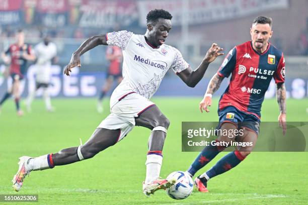 Michael Kayode of Fiorentina and Filip Jagiello of Genoa vie for the ball during the Serie A TIM match between Genoa CFC and ACF Fiorentina at Stadio...