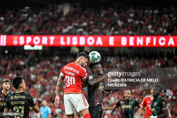 Benfica's Argentine defender Nicolas Otamendi and Estrela da Amadora's Portuguese forward Ronaldo Tavares vie for a header during the Portuguese...