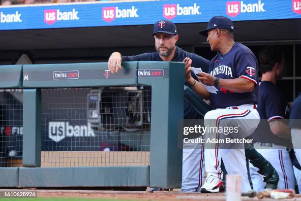 Rocco Baldelli and Tony Diaz of the Minnesota Twins discuss the game in the third inning against the Pittsburgh Pirates at Target Field on August 19,...