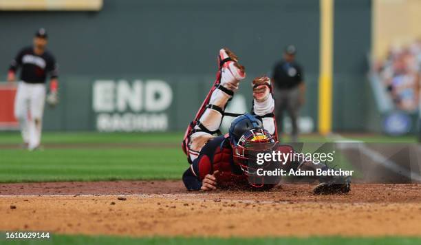 Christian Vazquez of the Minnesota Twins unsuccessfully attempts the tag on Ji Hwan Bae of the Pittsburgh Pirates in the sixth inning at Target Field...