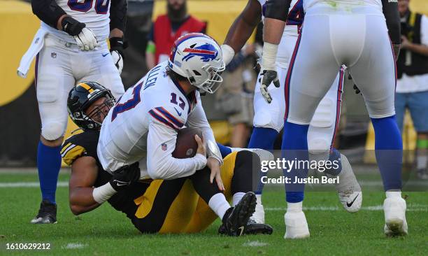 Josh Allen of the Buffalo Bills is tackled by Alex Highsmith of the Pittsburgh Steelers in the first quarter during a preseason game at Acrisure...