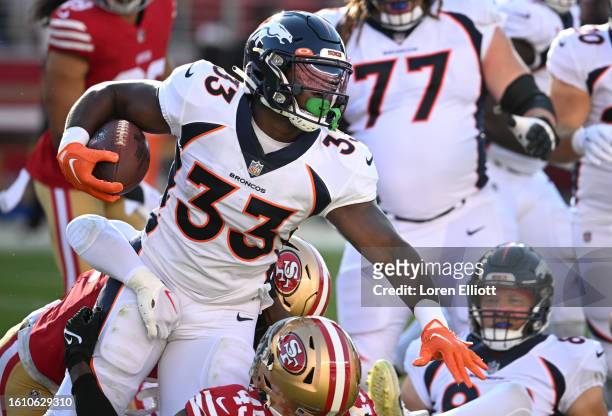 Javonte Williams of the Denver Broncos fights for yardage during the first half of a preseason game against the San Francisco 49ers at Levi's Stadium...