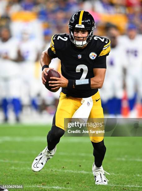 Mason Rudolph of the Pittsburgh Steelers carries the ball during the third quarter of a preseason game against the Buffalo Bills at Acrisure Stadium...