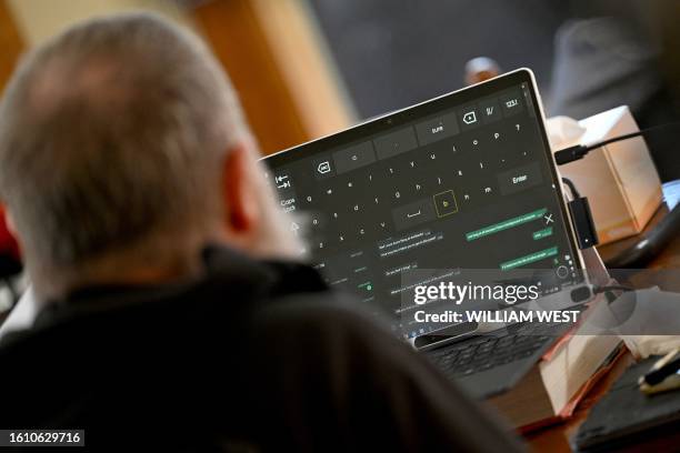 Photo taken on August 3, 2023 shows Rodney Gorham, a recipient of a Synchron brain implant, working on a computer at his home in Melbourne. As a rare...