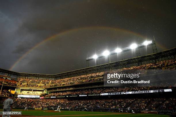 Kyle Freeland of the Colorado Rockies pitches against the Chicago White Sox in the fourth inning in a general view as rain falls and a rainbow is...
