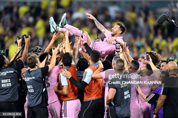 Teammates hold up Inter Miami's Argentine forward Lionel Messi as they celebrate after winning the Leagues Cup final football match against Nashville...