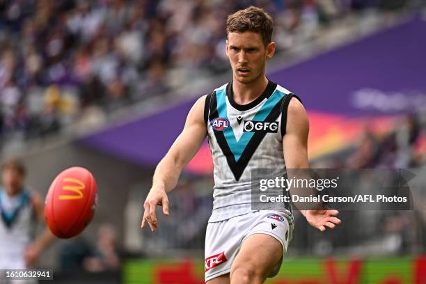 Kane Farrell of the Power kicks the ball during the 2023 AFL Round 23 match between the Fremantle Dockers and the Port Adelaide Power at Optus...