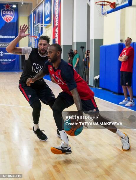 French basketball player Amath Mbaye and his teammate Nikita Kurbanov attend a CSKA Moscow training session in Moscow, on August 18, 2023....