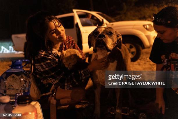 Evacuees Shay Nicole and Paryss Nicole stay with their family and pets at the Jim Lind Arena after registering with Emergency Support Services after...