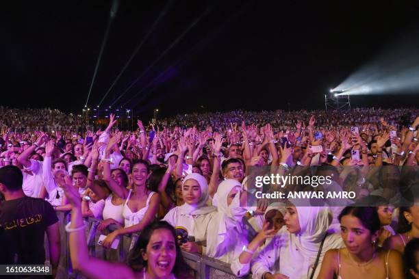 Fans cheer during a concert by Egyptian singer Amr Diab at the Beirut Waterfront Arena in the Lebanese capital late on August 19, 2023.