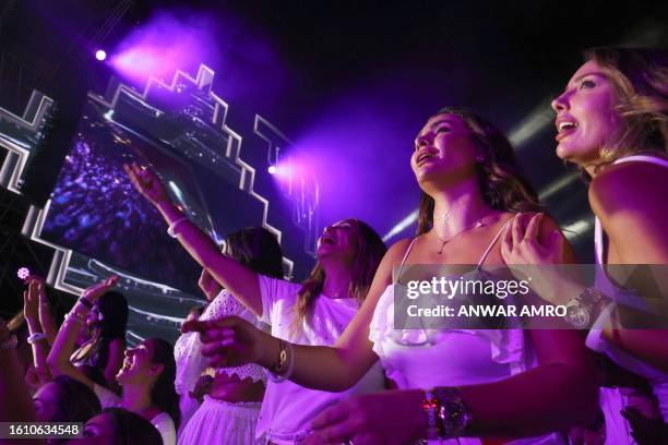 Fans cheer during a concert by Egyptian singer Amr Diab at the Beirut Waterfront Arena in the Lebanese capital late on August 19, 2023.