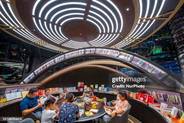 People read and buy books in Zhongshuge Bookstore in Huai 'an City, Jiangsu Province, China, Aug. 19, 2023.