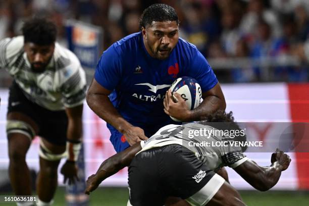 France's hooker Peato Mauvaka is tackled by Fiji's scrum-half Frank Lomani during the pre-World Cup friendly rugby union international match between...