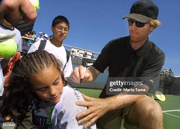 Tennis player Jim Courier signs an autograph during Arthur Ashe Kids'' Day August 25, 2001 at the USTA National Tennis Center in Flushing...