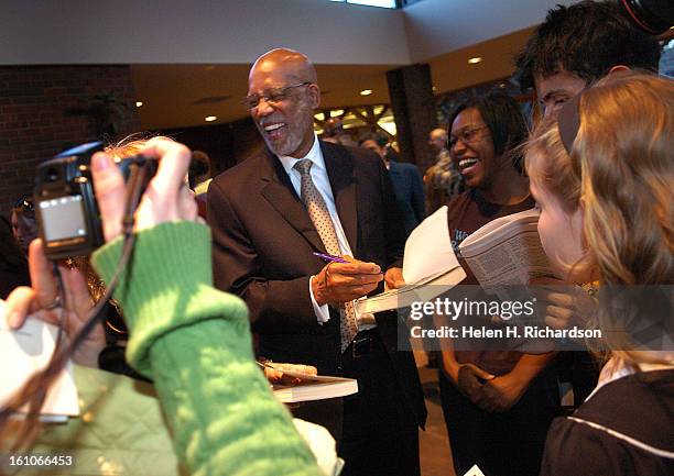 Terrence Roberts signs autographs for eager fans after the interfaith service at Congregation Emanuel <cq>. The nine members of what is now called...