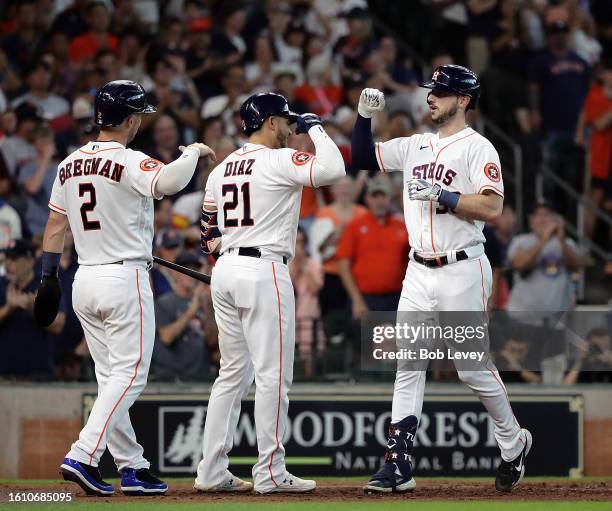 Kyle Tucker of the Houston Astros is congratulated by Yainer Diaz and Alex Bregman after hitting a three-run home run in the fourth inning against...