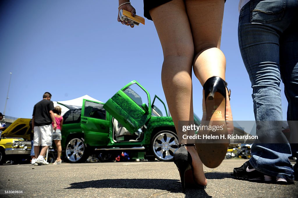 (EL) ABOVE: Passersby admire a tricked out 2000 GMC Denali created by Antonio Trujillo. Trujillo said he paid about $12,000 for the car and put another $60,000 into creating what it looks like now. The 2008 LOWRIDER Tour made a stop at the Denver Coliseum