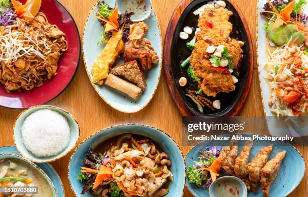 asian fusion food table. - nazar abbas photography stock pictures, royalty-free photos & images