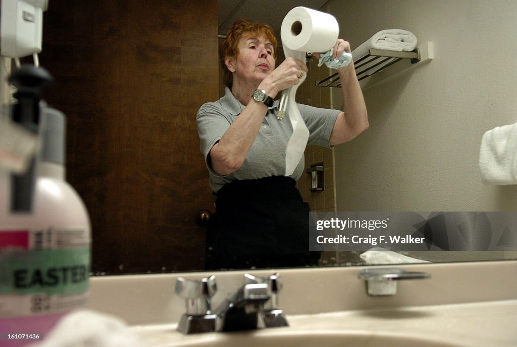 (KL) DDCOUPLE_042007_CFW APRIL 20, 2007- Pam Smaidris straightens a toilet paper roll while working with her Easter Seals Enclave at the Four Points by Sheraton Denver Cherry Creek. As a housekeeper Pam has cleaned over 11,000 hotel rooms over the past 10