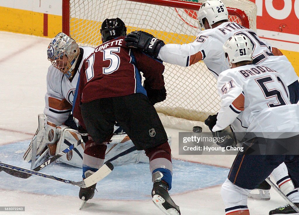 (hc) Avs vs. Oilers - Colorado Avalanche Andrew Brunette (15) scores 2nd goal against Edmonton Oilers goalie Dwayne Roloson during the 2nd period of the game at Pepsi Center on Friday. The Denver Post / Hyoung Chang
