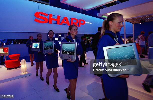 Models display new LCD TV monitors at the "Sharp" booth August 25, 2001 on the opening day of the International Broadcast Expo in Berlin, Germany....