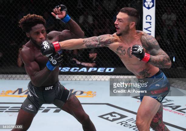 Cub Swanson punches Hakeem Dawodu of Canada in a featherweight fight during the UFC Fight Night event at UFC APEX on August 12, 2023 in Las Vegas,...
