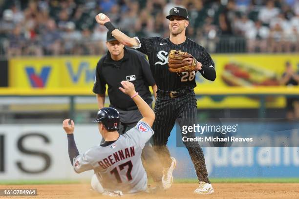 Zach Remillard of the Chicago White Sox turns a double play passed a sliding Will Brennan of the Cleveland Guardians at Guaranteed Rate Field on July...