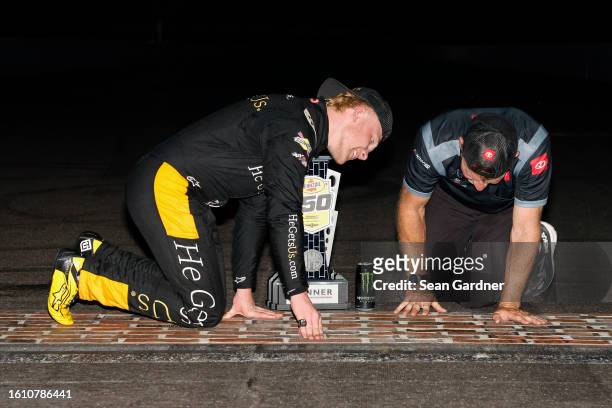 Ty Gibbs, driver of the He Gets Us Toyota, and crew chief Jason Ratcliff celebrates at the bricks after winning the NASCAR Xfinity Series Pennzoil...