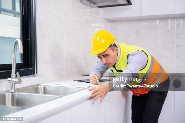 a house inspector measured a level of the kitchen counter in a new house - counter surface level stock pictures, royalty-free photos & images