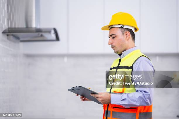 a house inspector checking a quality of the kitchenware in a new house - counter surface level stock pictures, royalty-free photos & images