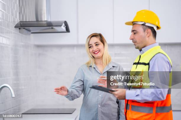 a house inspector checking a quality of the kitchenware in a new house - counter surface level stock pictures, royalty-free photos & images