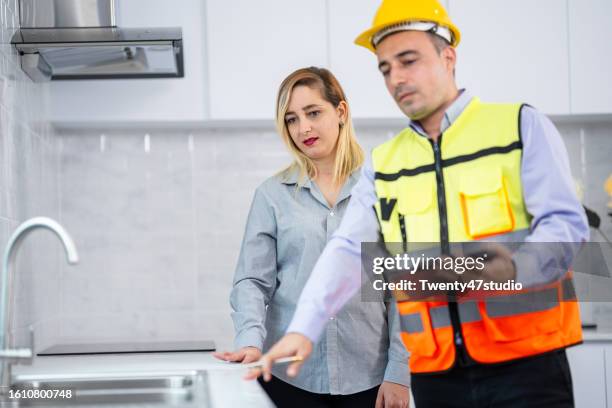 a house inspector checking a quality of the kitchenware in a new house - counter surface level stock pictures, royalty-free photos & images